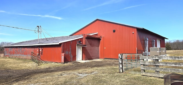 view of pole building featuring fence