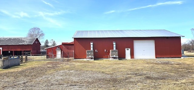 view of pole building with fence