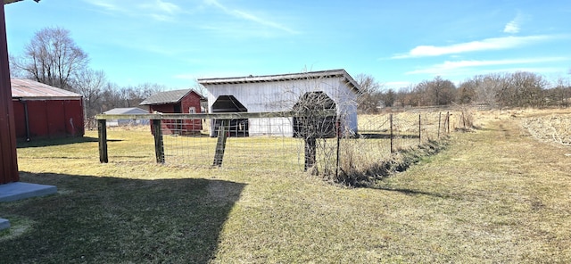 view of yard featuring an outbuilding and fence