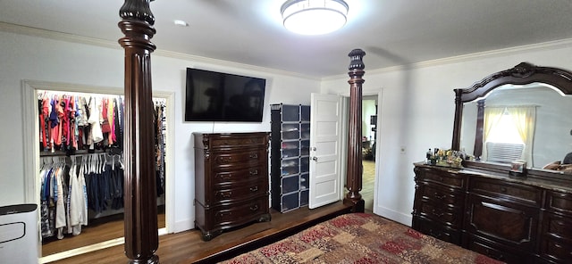 bedroom with crown molding, wood finished floors, and baseboards