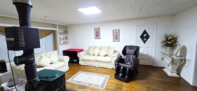 living area with wood finished floors, baseboards, and ornamental molding