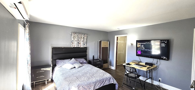 bedroom featuring wood finished floors and baseboards