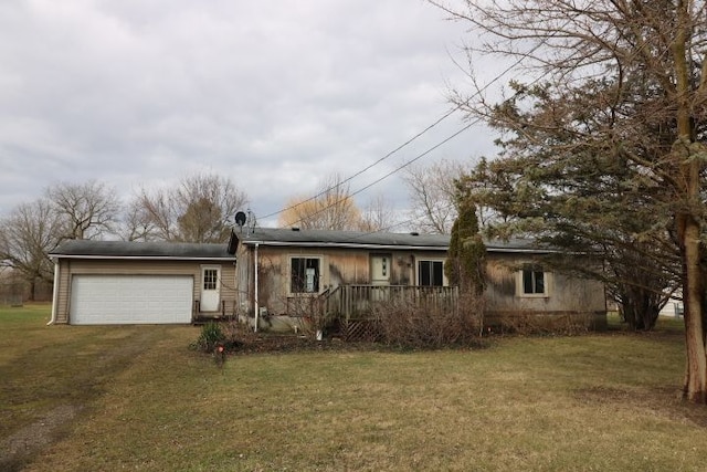 ranch-style house featuring an attached garage, driveway, and a front lawn