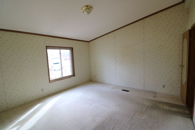 unfurnished room featuring carpet and wallpapered walls