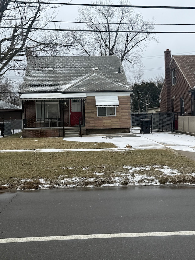 view of front facade with stone siding, entry steps, and fence