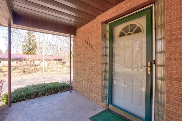 property entrance featuring brick siding