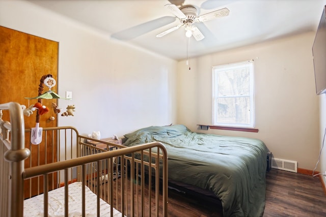 bedroom with visible vents, ceiling fan, baseboards, and wood finished floors