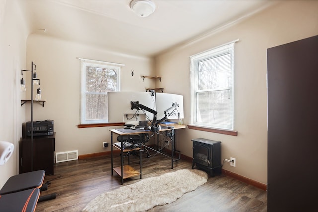 office with a wealth of natural light, baseboards, and wood finished floors