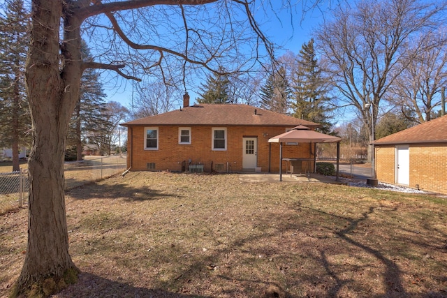 back of house featuring fence, crawl space, brick siding, a chimney, and a patio area