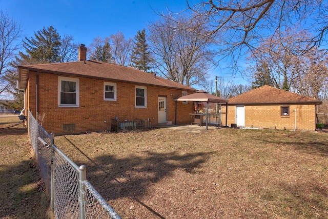 back of house with crawl space, fence, brick siding, and a chimney