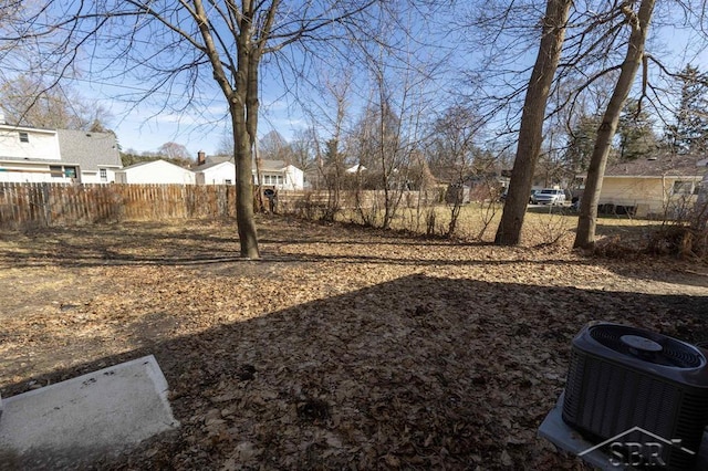 view of yard featuring cooling unit, a residential view, and fence