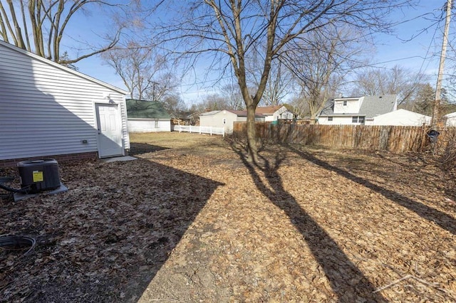 view of yard featuring cooling unit and fence