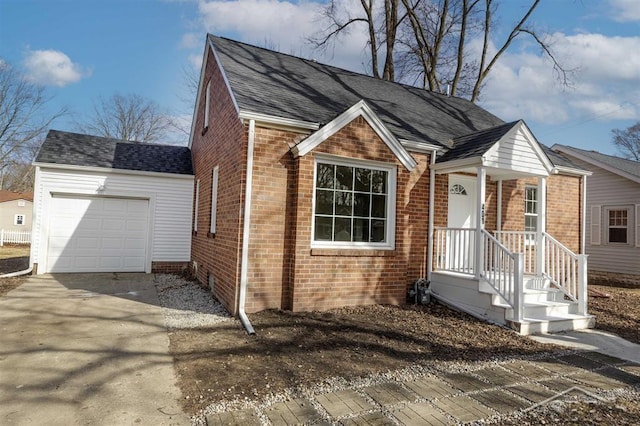 view of front of home featuring driveway, brick siding, an attached garage, and a shingled roof