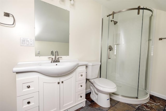 bathroom with vanity, baseboards, a stall shower, stone finish floor, and toilet