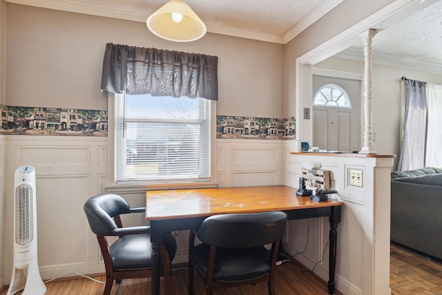 dining room featuring a wainscoted wall, wood finished floors, and ornamental molding