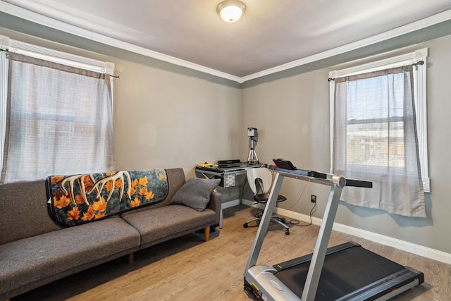 exercise room with baseboards and wood finished floors