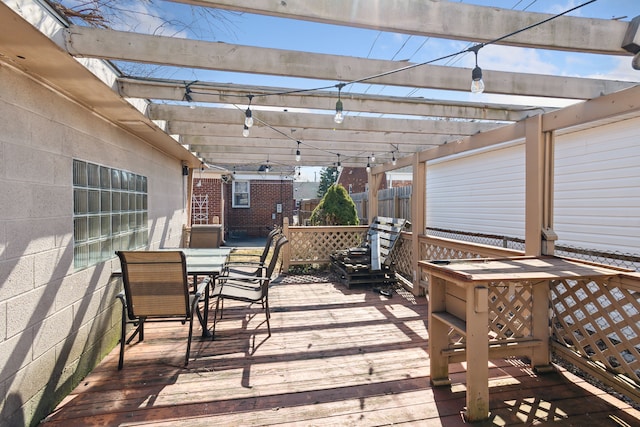 deck with outdoor dining space and a pergola