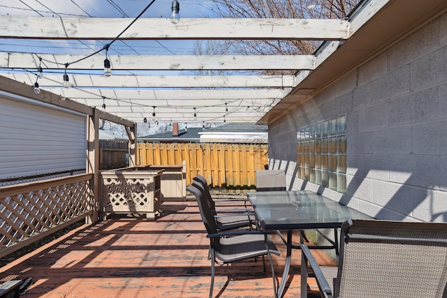 wooden terrace featuring outdoor dining space and fence