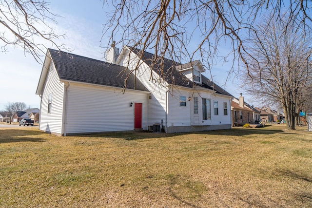 view of property exterior featuring a yard, a chimney, and a shingled roof