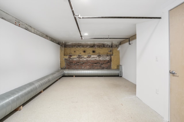 basement with brick wall