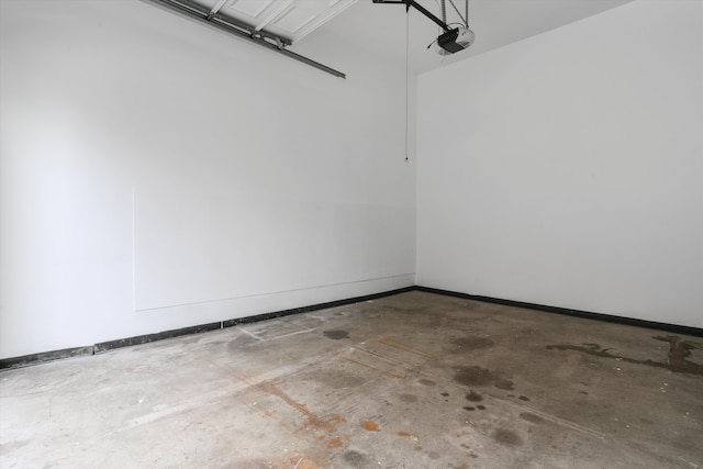 garage featuring a garage door opener and baseboards