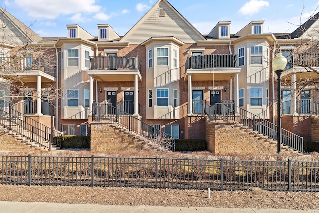 view of property with fence and brick siding