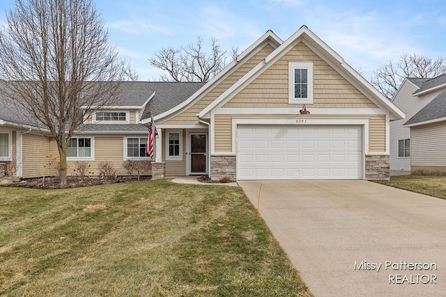 view of front of home featuring a front lawn, concrete driveway, roof with shingles, stone siding, and an attached garage