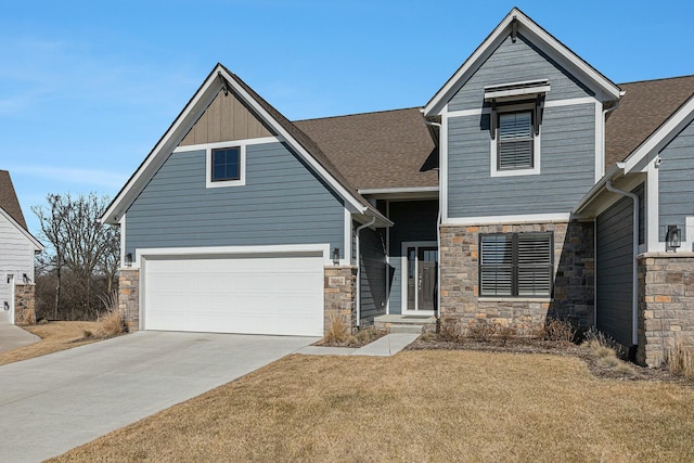 view of front of property with stone siding, driveway, and a shingled roof