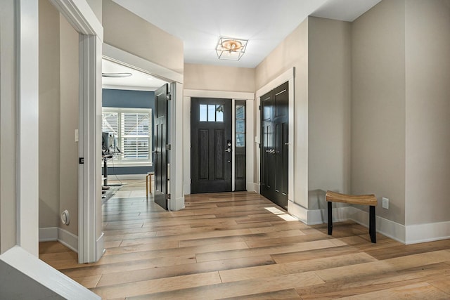 entrance foyer featuring light wood-style floors and baseboards