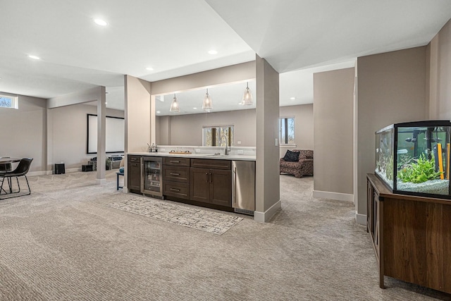 bar with baseboards, beverage cooler, light carpet, recessed lighting, and a sink