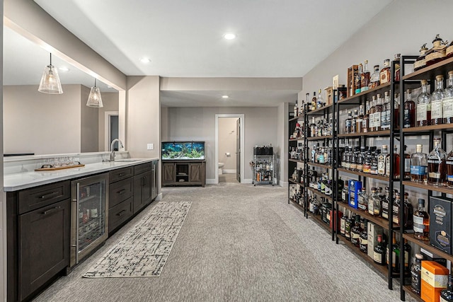 bathroom with baseboards, wine cooler, toilet, recessed lighting, and vanity