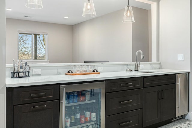 interior space with visible vents, pendant lighting, a sink, wine cooler, and a dry bar