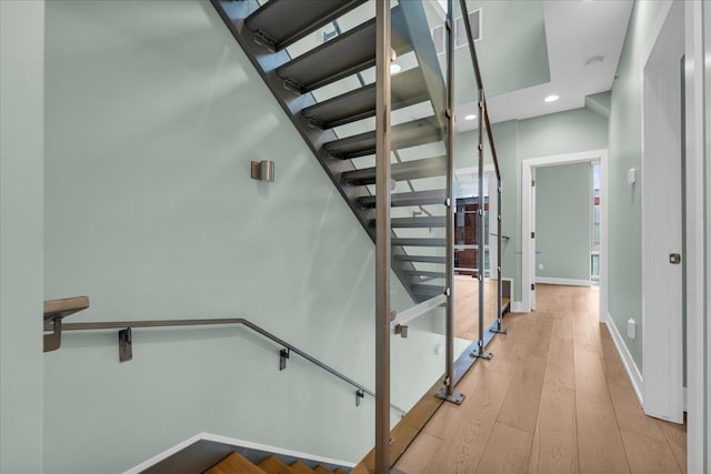 stairs with recessed lighting, baseboards, and wood finished floors