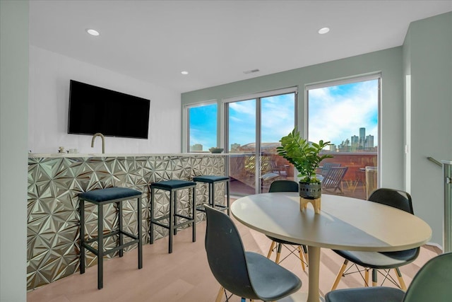 dining space with recessed lighting and wood finished floors