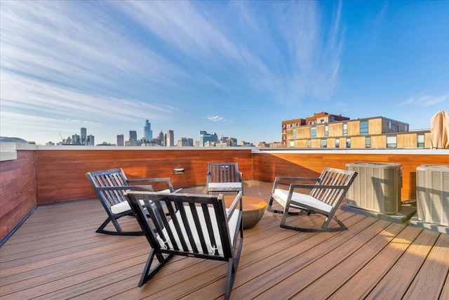 wooden terrace featuring a view of city and central AC unit