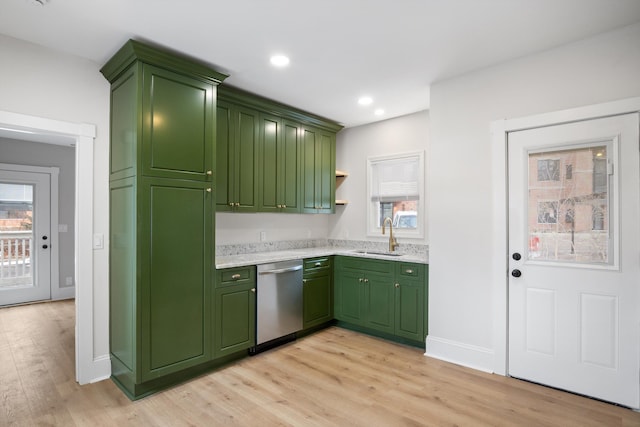kitchen featuring green cabinets, dishwasher, recessed lighting, a sink, and light wood-style floors