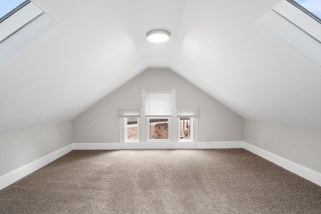 additional living space featuring baseboards, lofted ceiling, and carpet