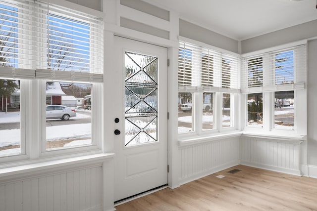unfurnished sunroom featuring plenty of natural light and radiator