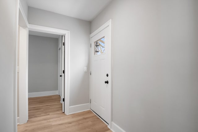 foyer entrance featuring baseboards and light wood-type flooring