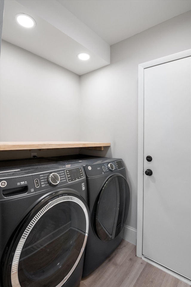 laundry room with recessed lighting, independent washer and dryer, baseboards, laundry area, and wood finished floors