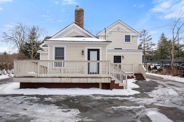 snow covered house with a chimney
