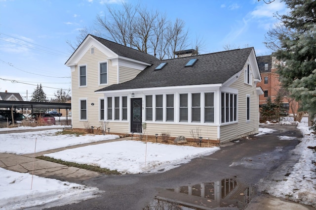 traditional-style home with a chimney and a shingled roof
