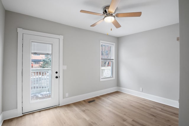 entryway with visible vents, a ceiling fan, light wood-style flooring, and a healthy amount of sunlight