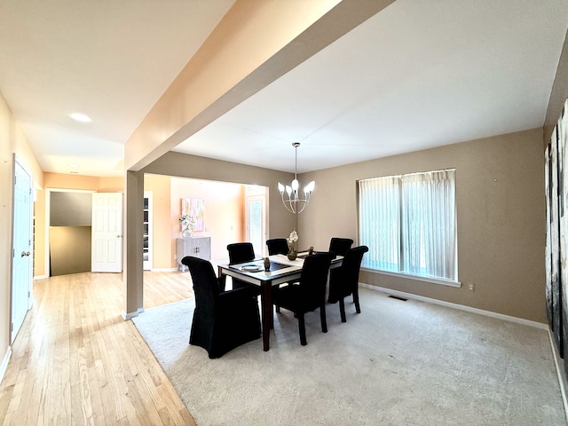 dining room with visible vents, baseboards, an inviting chandelier, and light wood-style flooring