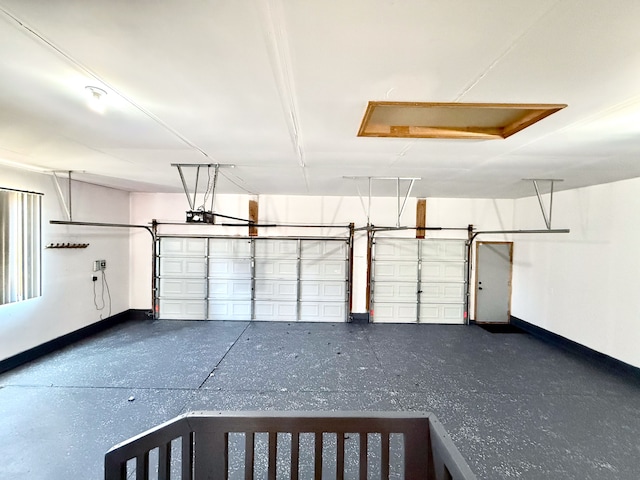 garage with baseboards and a garage door opener