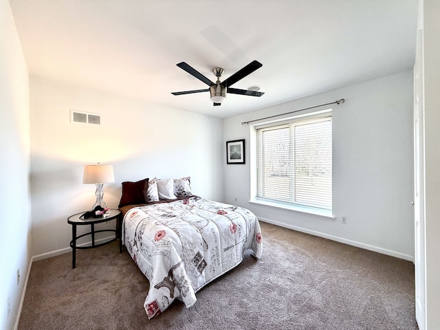 carpeted bedroom featuring visible vents, a ceiling fan, and baseboards