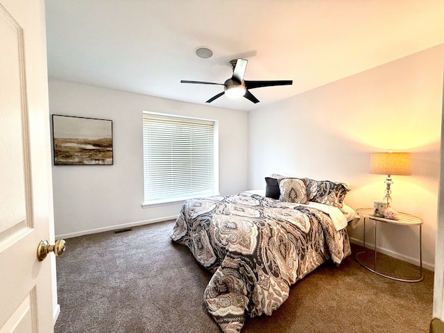 carpeted bedroom with baseboards, visible vents, and ceiling fan