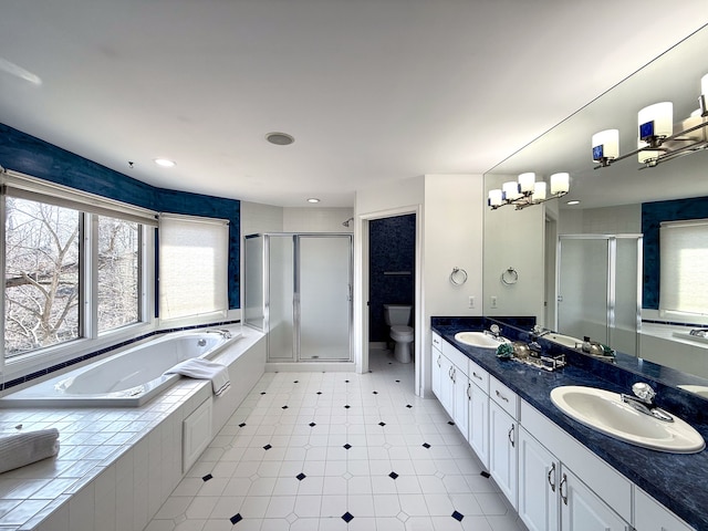 full bath featuring a bath, a shower stall, toilet, and a sink