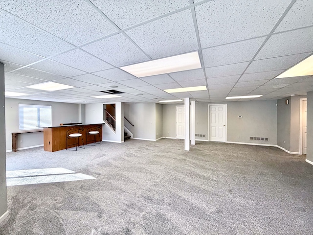 basement featuring visible vents, carpet floors, baseboards, and stairs