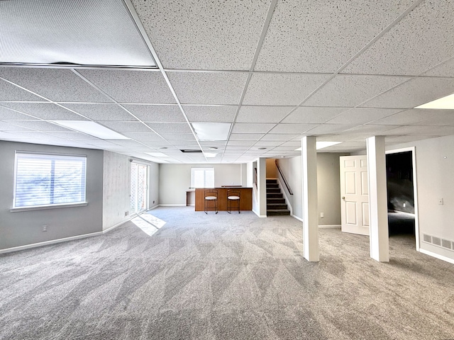 below grade area with stairway, carpet floors, and baseboards